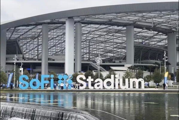A stadium with a large sign reading "SoFi Stadium" and a water feature in front. - 2BR Beach Escape-Steps to Manhattan Beach Pier (Manhattan Beach)