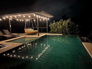 A swimming pool with a swing chair, a covered seating area, and string lights. - Studio w/Pool • Near Downtown Turrialba (Turrialba)
