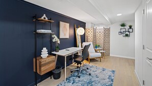 A modern office space with a desk, chair, and shelving unit. - Old Town Living- Xcape to Vibrant Old Town (Alexandria)