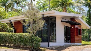 A modern house with a flat roof, large windows, and a mix of white and dark wood exterior. - Villa 2 (2BR) w/Pool • Near Downtown Turrialba (Turrialba)