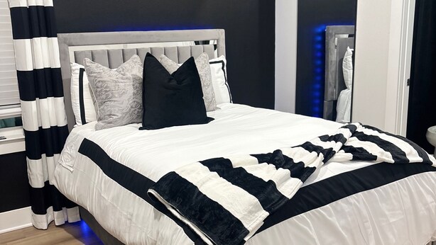 A modern bedroom with a bed, curtains, and a nightstand. - High End Luxury 3bedroom Located Near Downtown Houston (Houston)