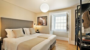 A hotel room with two beds, a large window, a wardrobe, and a wall-mounted picture. - Bica 246 by luma (Lisboa)