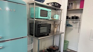 A compact kitchen with a teal refrigerator, a microwave, a toaster, and a stove. - Beach Paradise on Venice Island (Venice)
