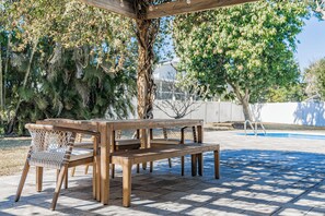 Outdoor dining - Coastal Canopy | Pool, Hot Tub, Pergola & Huge Fenced Yard – 4BR Near Beach ( 5 Min Drive) (Seminole)