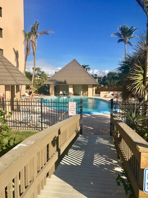 A pool area with a sign instructing to shower before entering. - 🐠 HIGHLY RATED! Remodeled Sea Winds Beachfront 10th Floor Double Vanity Sinks (Marco Island)