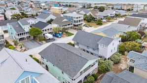 Zona residencial costera con casas con balcones y una playa al fondo.