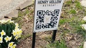 A sign for Henry Hollow Retreat with a QR code. - Lakefront w/ hot tub, firepit, BBQ, smoker, kitchen, patios, king bed, 1.5 bath (Eureka Springs)