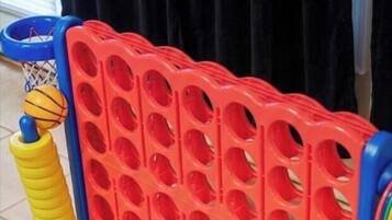 A red and blue playpen with a soccer ball and a basketball.