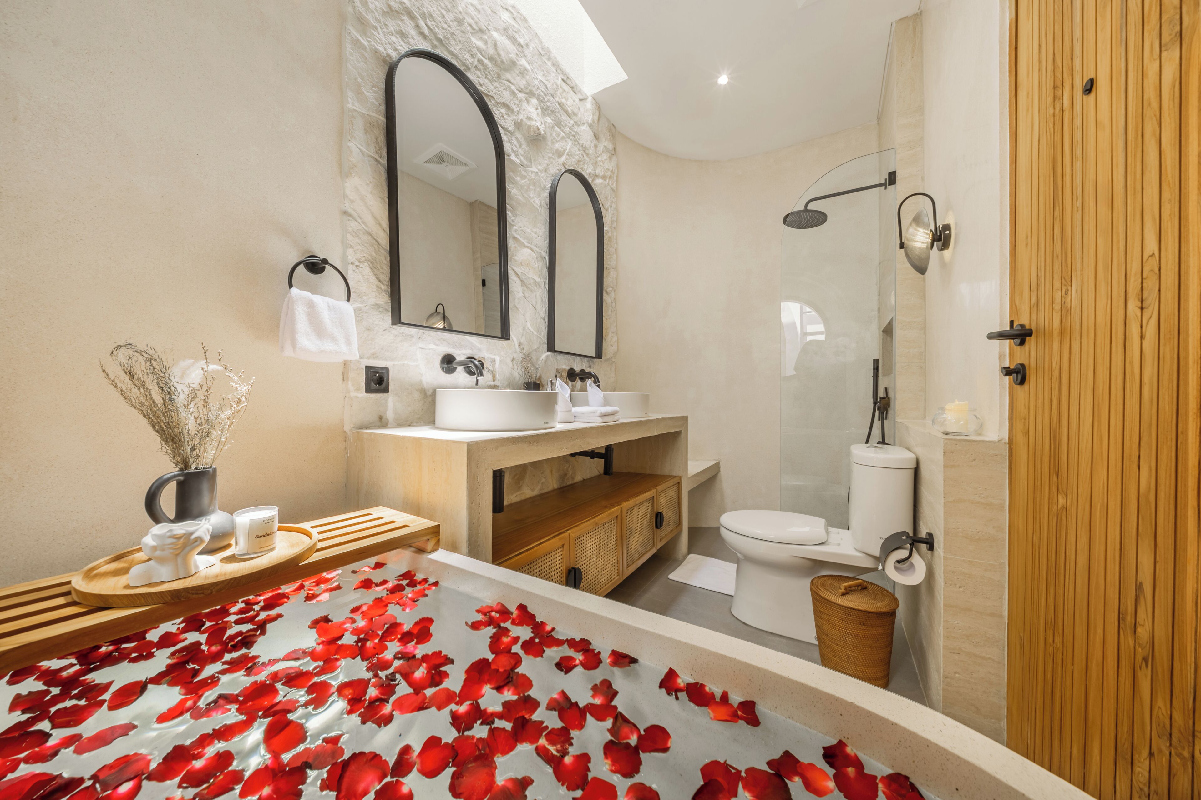 A modern bathroom with a bathtub, a shower, and a toilet.