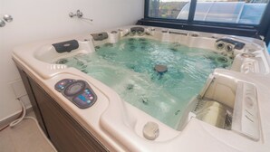 A hot tub with a control panel, a window view, and a built-in heater. - Family-friendly hillside villa with pool, jacuzzi, sauna, terrace, and scenic Medvednica views. (Strmec Stubički)