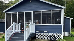 A small, single-story building with a porch and a covered entryway.