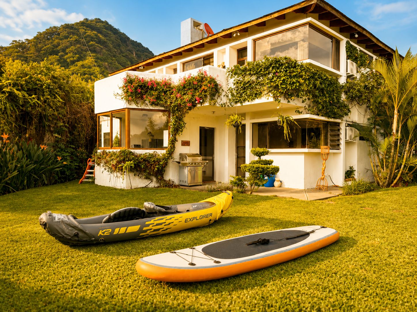 Una casa moderna con un césped cuidado, un kayak y una tabla de remo.