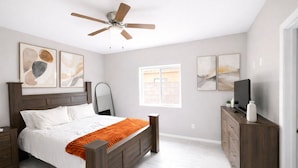 A bedroom with a bed, a dresser, a TV, and artwork on the walls. - Southwest Tucson Corner Retreat "Close to Great food and Shopping" (Tucson)