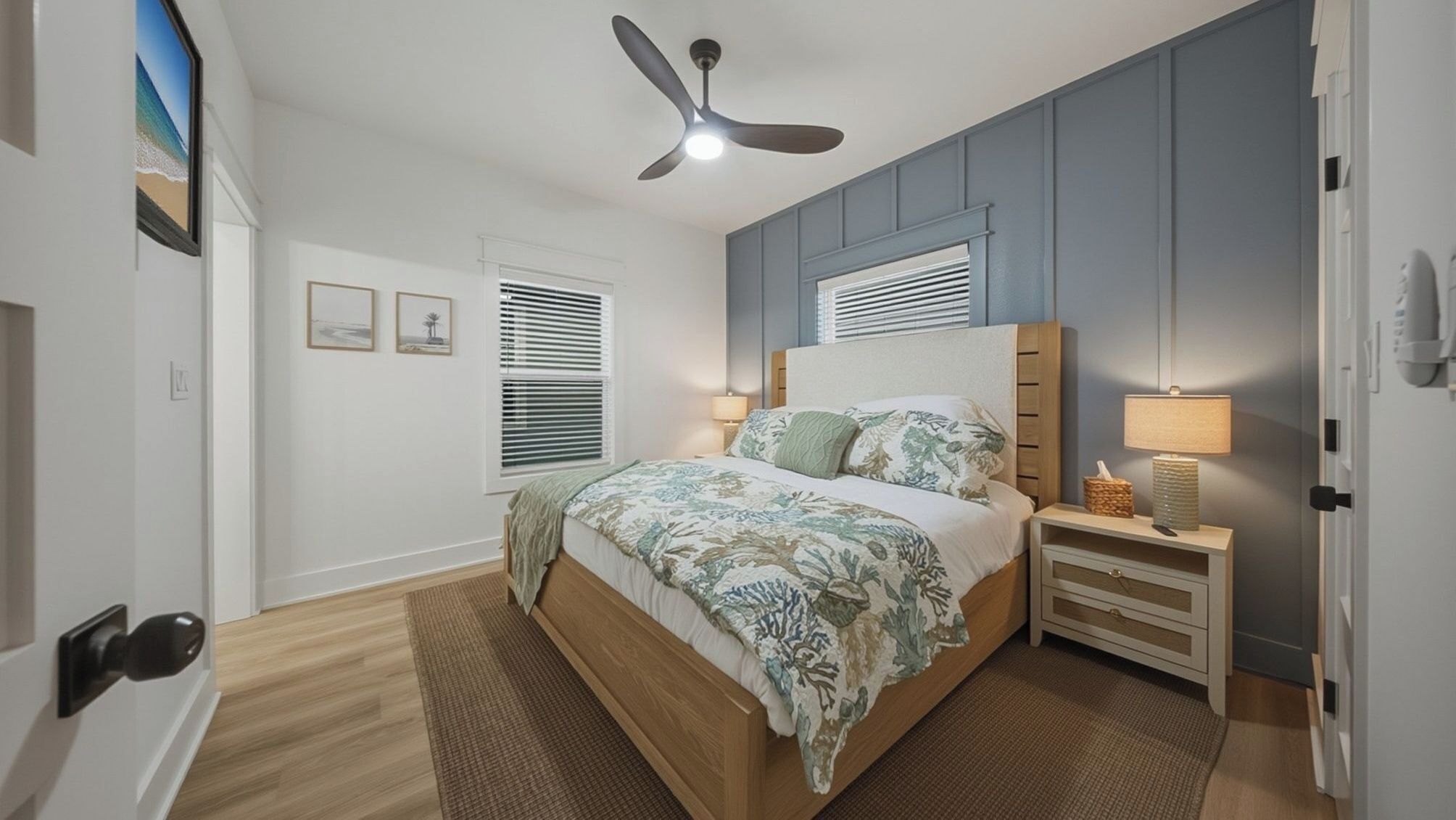 A bedroom with a bed, nightstands, a ceiling fan, and a window with blinds.