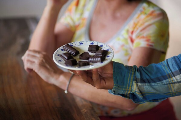 Una persona sosteniendo un plato con trozos de chocolate.