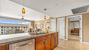 A modern kitchen with a large island, stainless steel appliances, and pendant lighting. - Maui Resort Rentals: Honua Kai - 3 Total Bedrooms, 6th Floor Partial Ocean AND West Maui Mountain Views! (Lahaina)