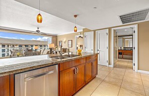 A modern kitchen with a large island, stainless steel appliances, and pendant lighting. - Maui Resort Rentals: Honua Kai - 3 Total Bedrooms, 6th Floor Partial Ocean AND West Maui Mountain Views! (Lahaina)