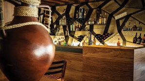A rustic bar area with wooden furniture and a large vase. - Fiji -Wyndham- Beachfront Resort- Denarau - 3 BR (Nadi)