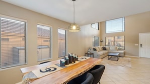 A spacious living area with a dining table, chairs, a sofa, and a coffee table. - Tranquil Retreat in Cave Creek (Cave Creek)