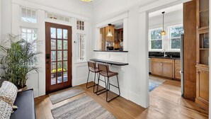 A spacious kitchen with wooden cabinets, a bar area, and a large window. - Comfort and Space with convenience (Atlanta)