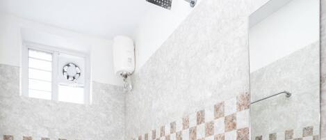 A bathroom with a toilet, sink, and shower.