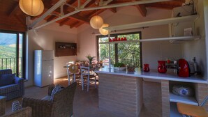 A spacious living area with a kitchen, dining area, and a view of the outdoors. - Holiday Home With Pool Near Assisi (Assisi)