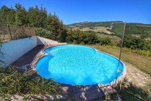 A swimming pool with a metal ladder, surrounded by a stone deck and a metal fence. - Holiday Home With Pool Near Assisi (Assisi)