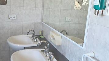 Presidential Studio Suite, Courtyard View | Bathroom | Hair dryer, towels, soap, shampoo