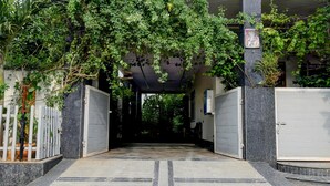 A gated entrance with a tiled pathway leading inside. - Villa Verizon by Dancenter (Hyderabad)