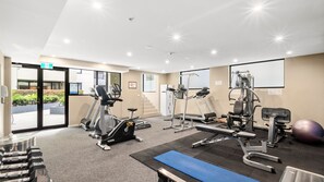 A gym with treadmills, elliptical machines, weight benches, and exercise balls. - Beachside Nook, Port Melbourne (Port Melbourne)