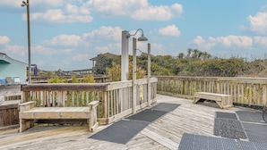 A wooden deck with a bench and a lamp post. - Steps to Beach! Emerald Isle Condo w/ Ocean View (Emerald Isle)
