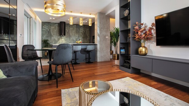 A modern living room with a dining area, a flat-screen TV, and a kitchen in the background. - Stay in a luxury apartment near Diocletian's Palace (Split)