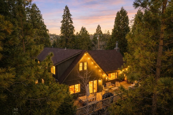 Golden hour magic in the pines—your Lake Arrowhead cabin glowing under a sunset sky.