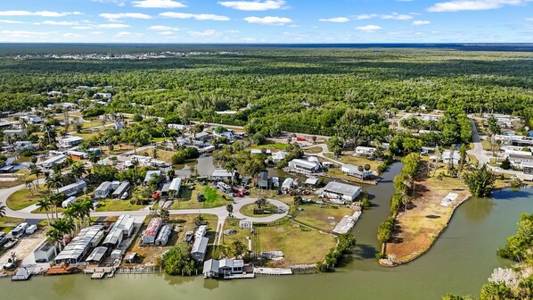 A residential area with multiple houses, a marina, and a river.