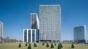 Een modern hotel met een opvallend verticaal ontwerp, meerdere verdiepingen en een heldere lucht.