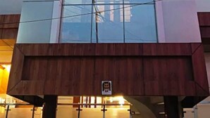 A hotel with a modern glass facade and a prominent sign reading "UDAY RAJ HOTEL". - Hotel Uday Raj (Agra)