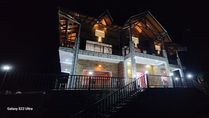 A multi-story building with balconies and a staircase leading to the entrance. - B'NEST By Baan Home Stay (Siloti Pant)
