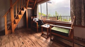 A wooden interior with a staircase, a sofa, and a table. - B'NEST By Baan Home Stay (Siloti Pant)