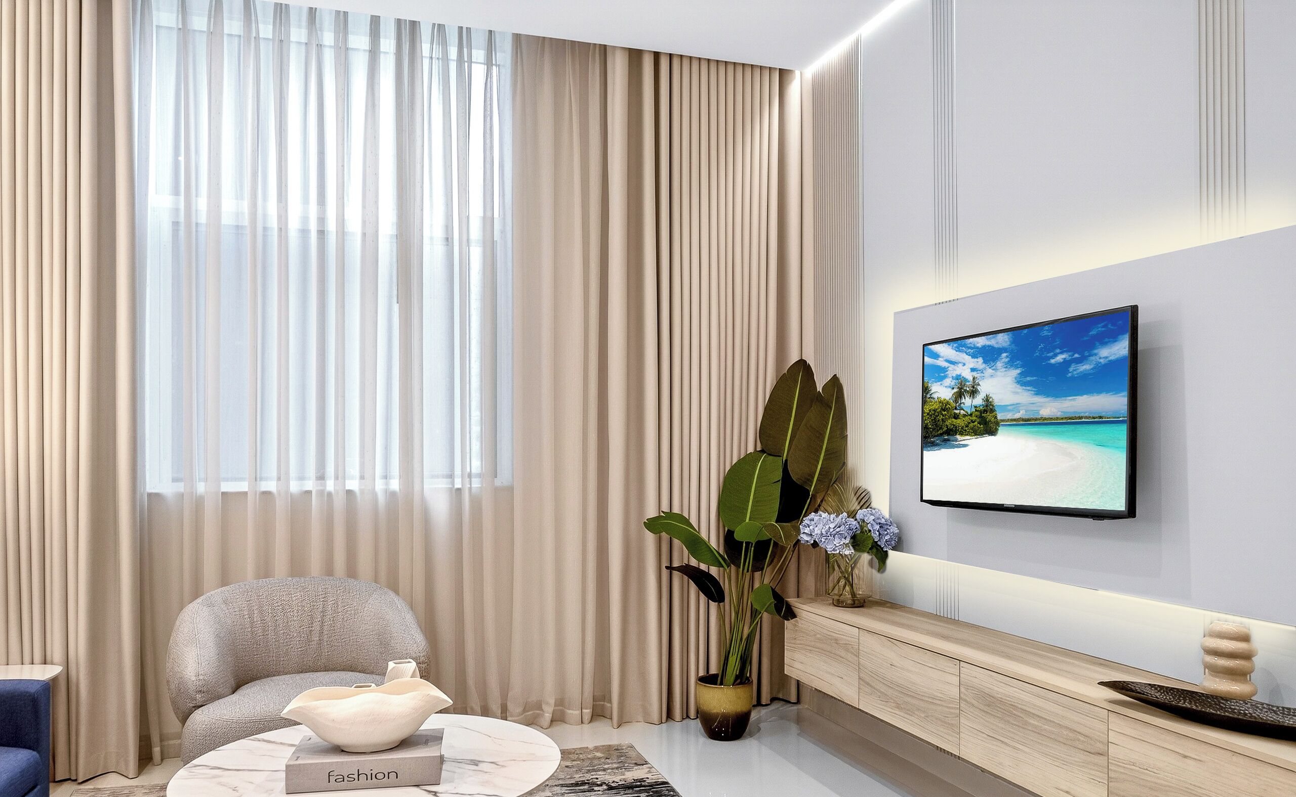 A modern living room with a sofa, a coffee table, a potted plant, and a TV mounted on the wall.