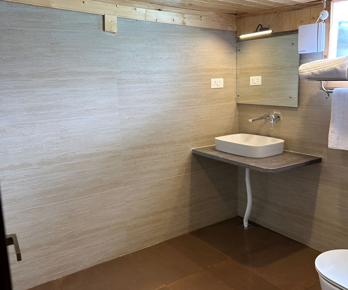 A bathroom with a white sink, a mirror, and a towel rack.