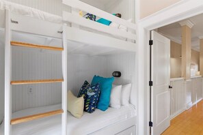 A white interior with a bunk bed, a white door, and a hallway leading to another room. - Watercolor Park Dist, Balcony Park View, Great Loc (Santa Rosa Beach)