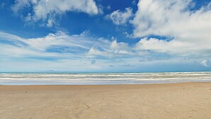 A beach with a clear sky and ocean. - Gulf-view Resort Retreat: Suntide III - Unit 209 (South Padre Island)