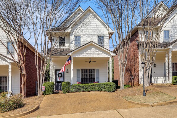 A two-story house with a front porch, a flag, and a brick chimney. - Oxford Blues: Spin Records Between Rebel Kickoffs (Oxford)