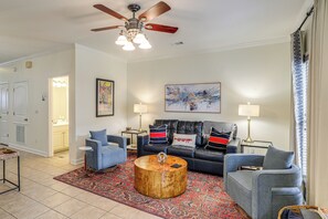 A living room with a ceiling fan, two sofas, a coffee table, and a patterned rug. - Oxford Blues: Spin Records Between Rebel Kickoffs (Oxford)