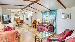 A cozy living room with a sofa set, a glass coffee table, and a dining area with a table and chairs. - Cabin w/ Lake Access in Fort Mccoy, Pets Welcome! (Fort McCoy)