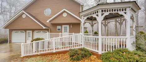 A two-story house with a covered porch and a garage.