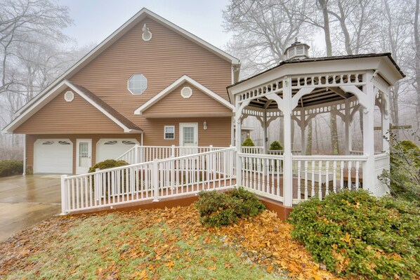A two-story house with a covered porch and a garage.