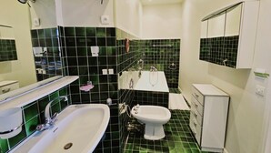 A bathroom with a white sink, a white toilet, and a mirror above the sink. - Family home, sleeps 8, terrace with panoramic view in Porquerolles (Hyères)