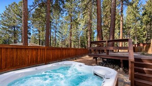 A hot tub in a forested area with a wooden deck and stairs leading up to it. - NEW property Private Skyland Beach,Modern Zephyr Cove Retreat,Hot Tub(ZC1034) (Zephyr Cove)