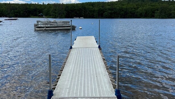 A wooden pier extending into a lake with boats docked at the end. - Wildflower Cabins Limit 6 3 Bedroom Villa (Naples)